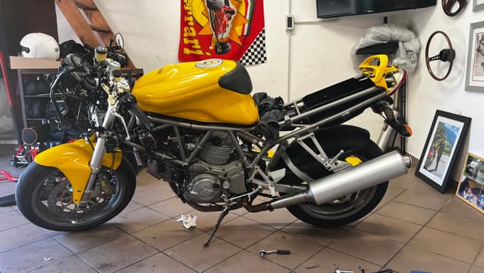 Yellow Ducati 750 SS project bike in the garage