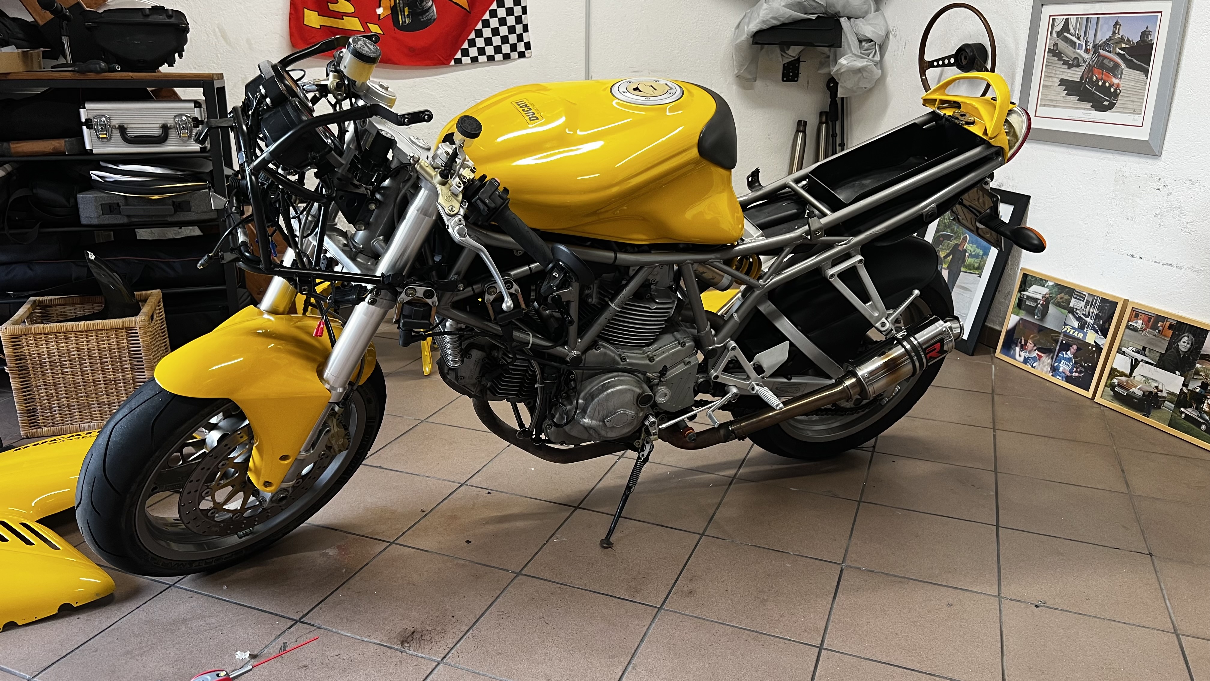Yellow Ducati 750 SS stripped down in the workshop