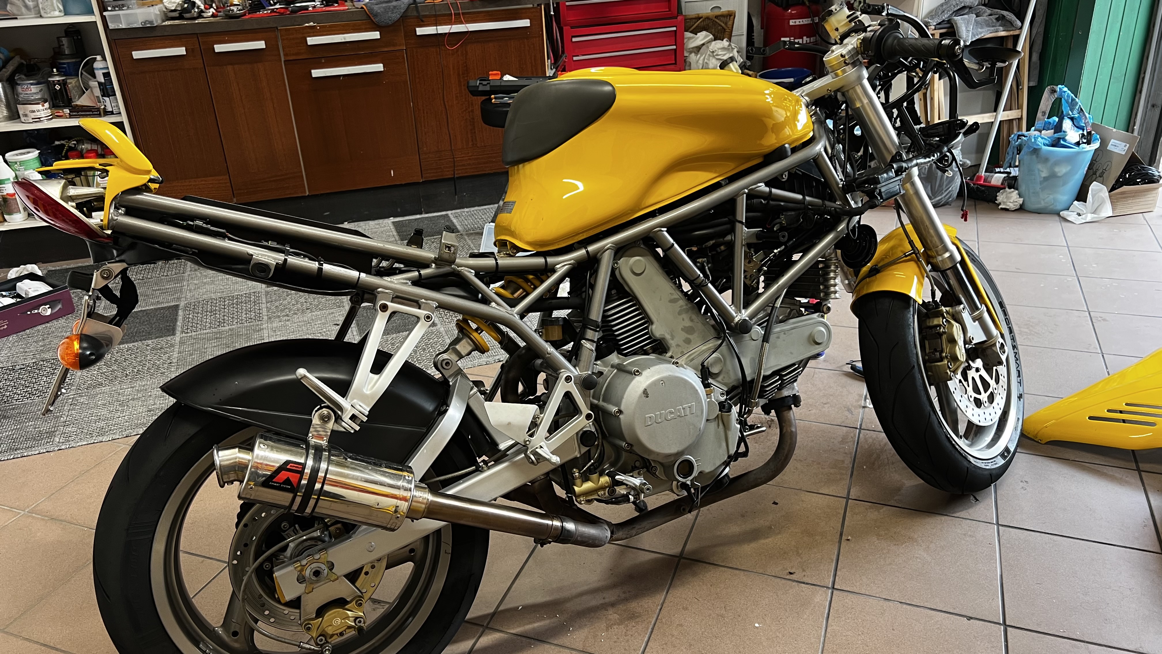 Yellow Ducati 750 SS in the garage during restoration