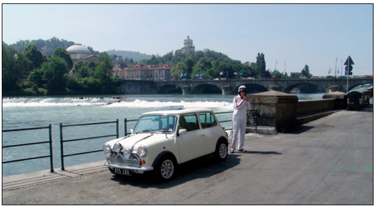 A classic Mini Cooper parked by the River Po in Turin at the weir crossed in The Italian Job